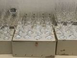 boxes of empty wine glasses sitting on top of a table