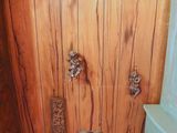wooden paneled wall in a bathroom with vases on the floor
