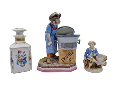 a figurine of a woman washing dishes with a child