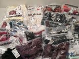 many different types of clothing in bags on the table