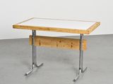 an image of a table with a white top and metal legs