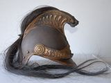 a helmet with long hair on a white surface