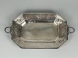 an antique silver tray with handles and handles on a white surface