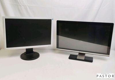 two computer monitors sitting next to each other on a table