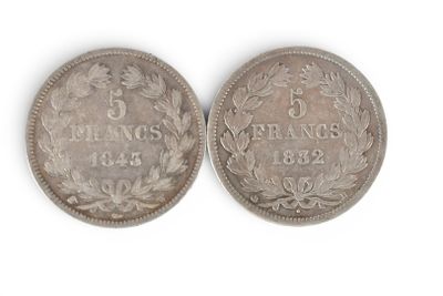 a close up of two silver coins on a white surface
