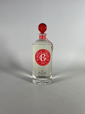 an image of a bottle of perfume sitting on a white surface