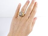a woman ' s hand with a ring on it