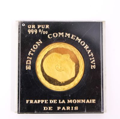 gold coin with a picture of a dog on it on a white surface