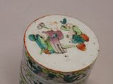 a small cup with a painting on it on a table