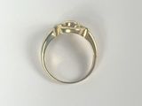 an image of a gold ring on a white surface
