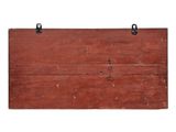 an old red wooden sign hanging on a white wall