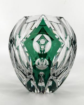 a glass vase with a green design on the inside of it
