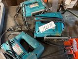 several electric tools are sitting on a table in a workshop