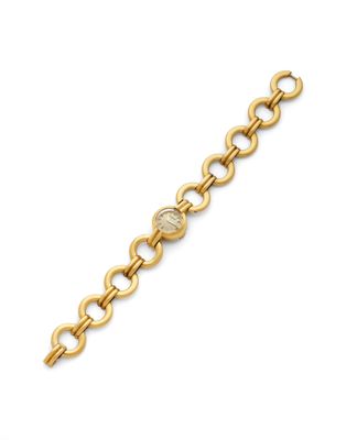 a gold bracelet with an oval link and a round clasp