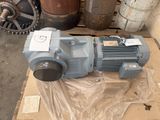 a blue motor sitting on a box in a warehouse