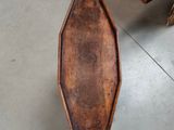 a small wooden box sitting on the floor next to a person ' s feet