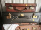 several pieces of luggage stacked on top of each other in a room