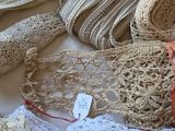 many different types of crocheted clothing on a bed