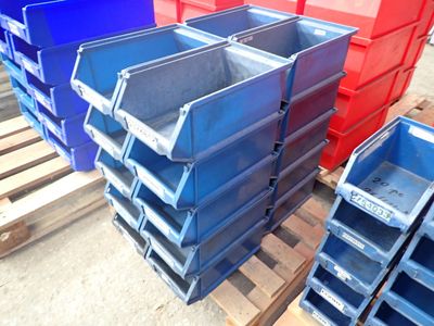 many blue and red bins stacked on a pallet