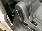 a close up of a seat in a car with a remote control