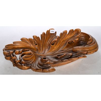 an image of a wooden carving of a peacock on a white background