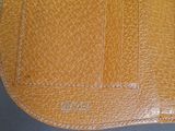 an image of a brown leather wallet sitting on top of a table