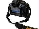 a black camera with a yellow strap attached to it