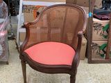 a brown chair with a pink seat and a brown chair with a red cushion