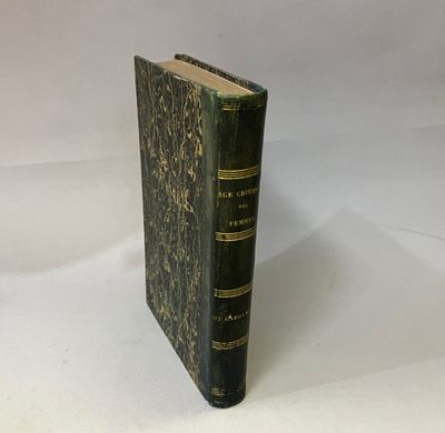 an old book sitting on top of a white table