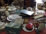 a table with a lot of clutter and dishes on it
