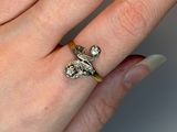 a woman ' s hand with a diamond ring on it