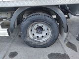 a flat tire on a flatbed truck parked in a parking lot