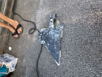 a person standing next to a broken skateboard on the street