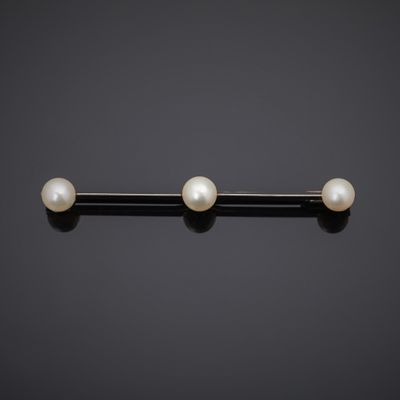 a pair of pearl and gold barbells