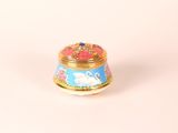 an image of a blue and gold box with a swan on it