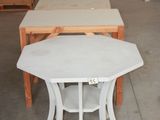 a table and two chairs in a warehouse area