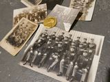 an old photo of a group of men in uniform posing for a picture