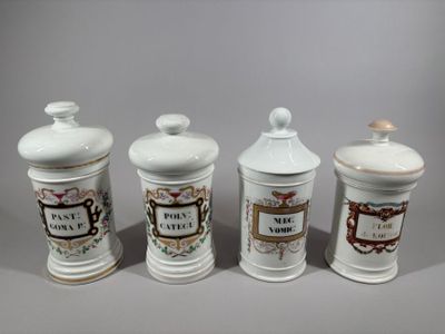 three white ceramic jars with decorative designs on them on a gray surface
