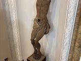 a statue of a man standing on a pedestal in a room