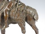 bronze statue of a man riding a horse with a spear in his hand