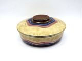 a small bowl with a lid on a white surface