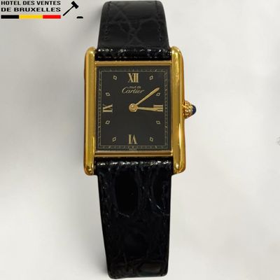 an image of a black and gold wrist watch with roman numerals