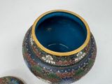 a blue vase with a gold rim and a blue vase with a gold rim