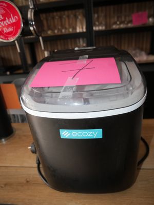 a black and white ice cream maker with a pink sticker on it