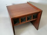 a small wooden table with a glass door on it