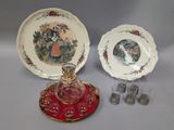 two plates and a glass bowl with a glass stopper on a tray