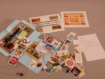 a pile of stamps and postcards on a table