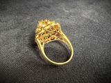 a close up of a gold ring on a black surface