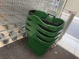 many green plastic bins sitting next to a shopping cart