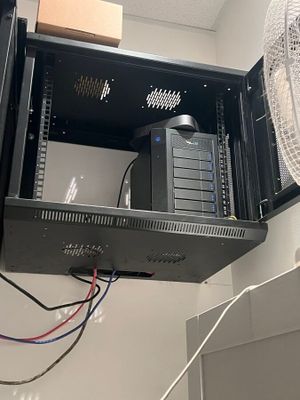 a fan that is sitting on top of a cabinet
